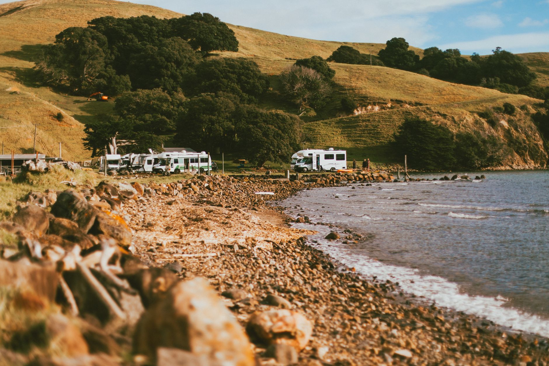 Campervan parked along coastal cliff in New Zealand